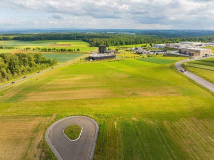 Wide green fields with a country road and surrounding rural landscape, ING Park development area,