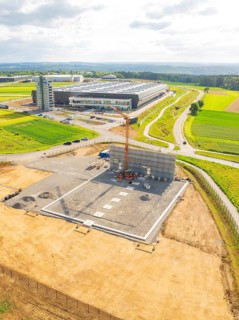 Aerial view of a construction site in the middle of a rural landscape with fields, ING Park