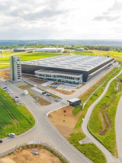 Bird's eye view of large industrial building with surrounding fields and roads, ING Park