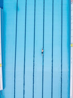 A lone swimmer does his laps in an empty pool, Calw outdoor pool, Black Forest, Germany