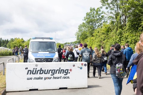 Festival visitors walk past a barrier on their way to the main entrance at the Rock am Ring
