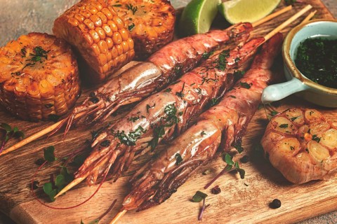 Langoustines on skewers, shrimp kebab, with fried corn, spices and herbs, homemade, no people