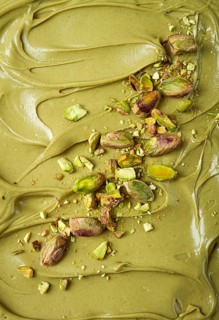 The texture of pistachio paste, with pistachios and crumbs, full frame, close-up