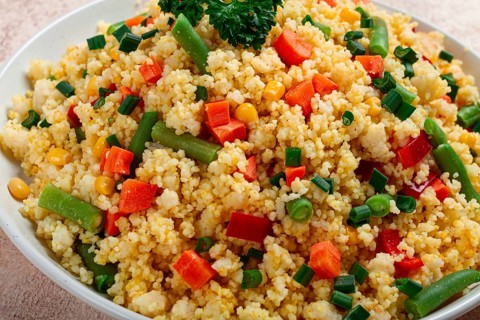 Couscous with vegetables, paprika, carrots, string beans, corn, homemade, top view, no people