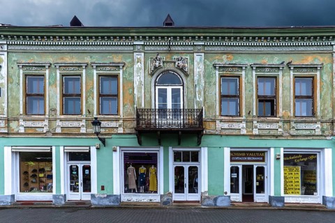 19th century house, restored shops on ground floor, upper floor not restored, Medias, Romania