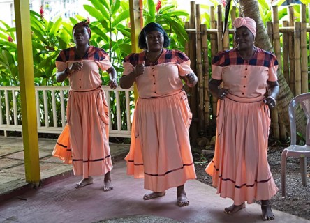 Guatemalan woman in traditional clothing singing and dancing, Garifuna people, Livingston, Izabal