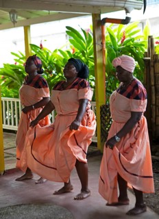 Guatemalan woman in traditional clothing singing and dancing, Garifuna people, Livingston, Izabal