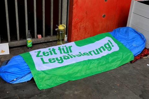 Sleeping bag and overnight place of a homeless person, on it a foil with the inscription Time for