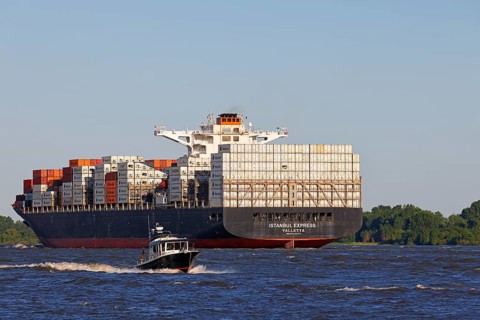 Container ship Istanbul Express sails up the Elbe towards the Port of Hamburg, shipping on the