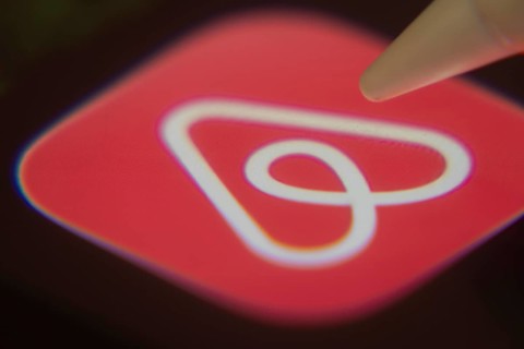 Dhaka, Bangladesh- 06 Dec 2025: Close-up of the Airbnb app on a screen with a stylus pointing at it