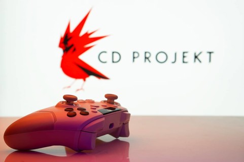 Dhaka, Bangladesh- 20 Mar 2025: A close-up of a white gamepad with the CD Projekt seen on screen in