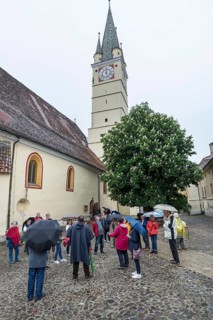 Tour group in the courtyard of St. Margaret's Church, Medias, Romania