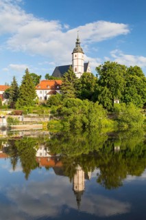 City view with church of Our Lady on the mountains and reflection in Zwickauer Mulde, Penig,