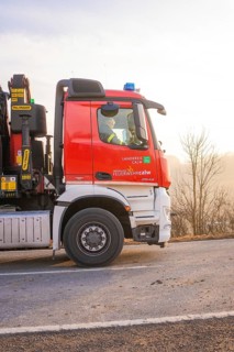 Red fire engine on a country road at sunset, fire brigade exercise on the Hermann Hesse Railway,