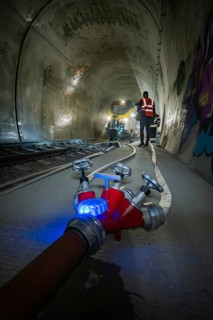 A water tap and fire hose in the foreground of a tunnel, fire brigade exercise on the Hermann Hesse