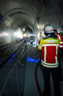 Deployment of firefighters in a tunnel with hoses and equipment, fire brigade exercise on the