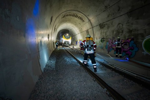 Firefighters working in an illuminated tunnel with graffiti, fire brigade exercise on the Hermann