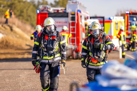 Two firefighters with respirators and full equipment on duty, fire brigade exercise on the Hermann