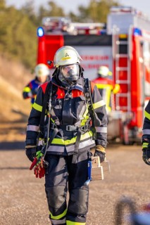 Firefighter wearing respirator and equipment during an operation, fire brigade exercise on the