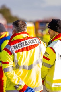 Rescue team wearing operational clothing in an emergency situation on a road, fire brigade exercise