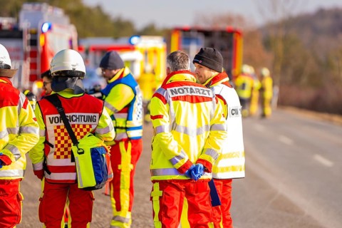 Group of rescue workers and firefighters on a street during an emergency operation, fire brigade