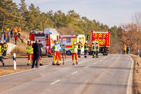 Accident on a country road, fire and emergency services on site with emergency vehicles, fire