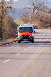 An ambulance drives along a winding country road, fire department exercise on the Hermann Hesse