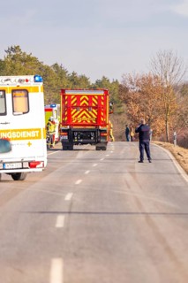 Emergency vehicles and a police officer on a rural road, fire department exercise on the Hermann