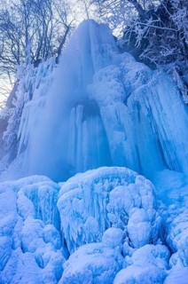 Urach waterfall full of bizarre ice formations frozen at winter temperatures, Bad Urach, Swabian