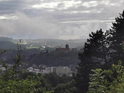 Fortress on a hill in fog with a view of a wide landscape, view over Kronach, Frankenwald nature
