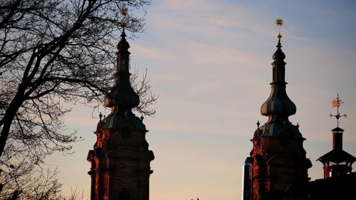 Church towers at sunset as silhouettes against a pastel-coloured sky, Franconian Forest nature park