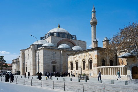 Historic mosque with minaret, many people animate the surrounding area, Mevlana Museum, Mevlana,