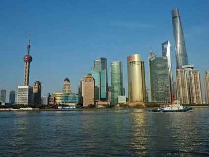 Modern urban skyline of Huangpu Jiang on the water under clear blue sky, Pudong, Shanghai, China