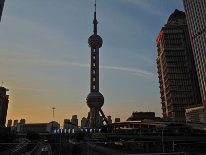 Oriental Pearl Tower in an urban skyline at sunset with skyscrapers in the background, Shanghai,