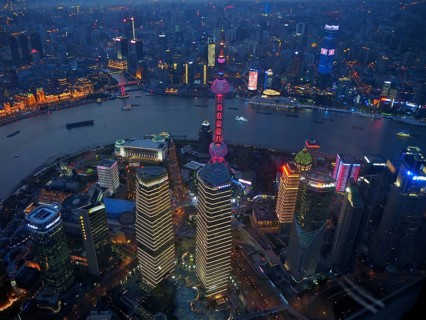 View of illuminated skyscrapers and river at night, Shanghai, China