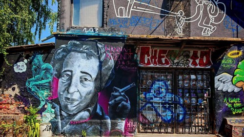 Colourful graffiti portrait on an urban wall with further figures and details, Ljubljana, Slovenia