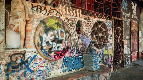 Different graffiti on a brick wall in an urban environment with a mix of cultures, Ljubljana,