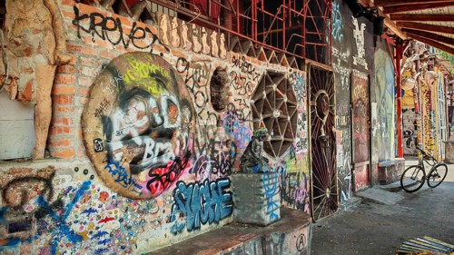 A mix of graffiti, art and bicycles on an urban brick wall with colors, Ljubljana, Slovenia