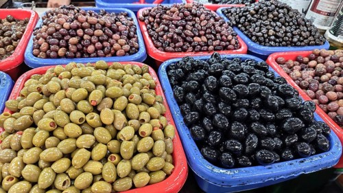 Colourful containers with different types of olives (olivae) at a market, Skopje, North Macedonia