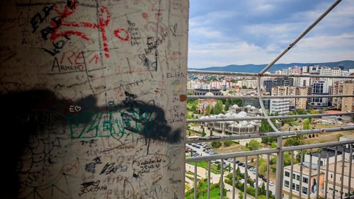 Wall with graffiti and cityscape in the background, Pristina, Kosovo