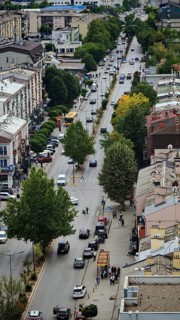 Aerial view of busy urban street with trees and vehicles, Pristina, Kosovo