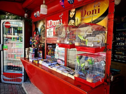 A colorful street kiosk with various products and drinks for sale, Kosovo