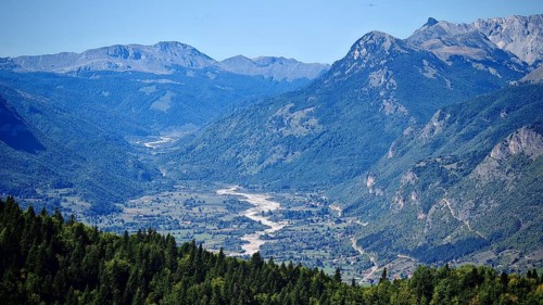 View of a mountain valley with a river surrounded by forests and mountains, Peaks of the Balkans,