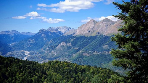 Impressive mountain landscape surrounded by green forests and clear skies, Peaks of the Balkans,