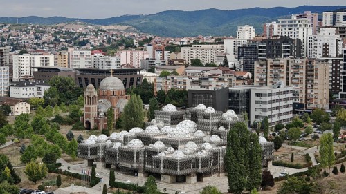 Modern dome buildings, view of Kosovo National Library Pjetër Bogdani in an urban landscape with
