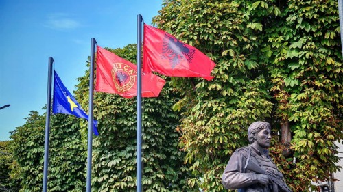 Memorial with flags of Kosovo, Albania and KLA against green background, Prizren, Kosovo