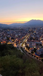 Evening panoramic view of the city with illuminated streets and river, Prizren, Kosovo