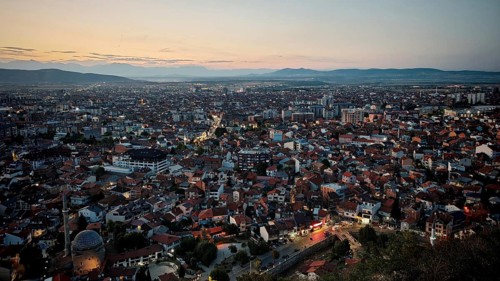 Extensive night view over the city with illuminated roads and hills, Prizren, Kosovo