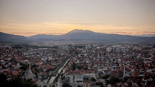 View of a city at sunset with river surrounded by mountains in the distance, Prizren, Kosovo