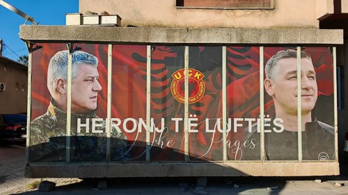 Portrait mural with KLA symbols war heroes on a building, Kosovo